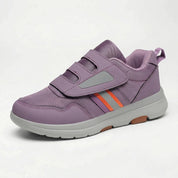 Sneaker ortopedica grigia con suola flessibile bianca, vista laterale